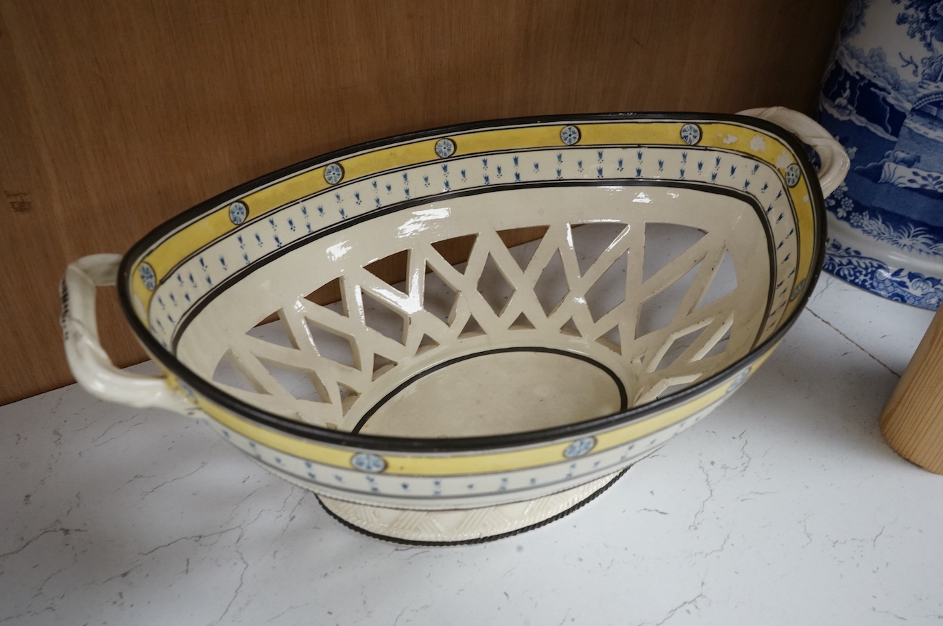 A George III creamware basket, a pearlware mug and jug, a Coalport spill vase (four), basket 26.5cm handle to handle.